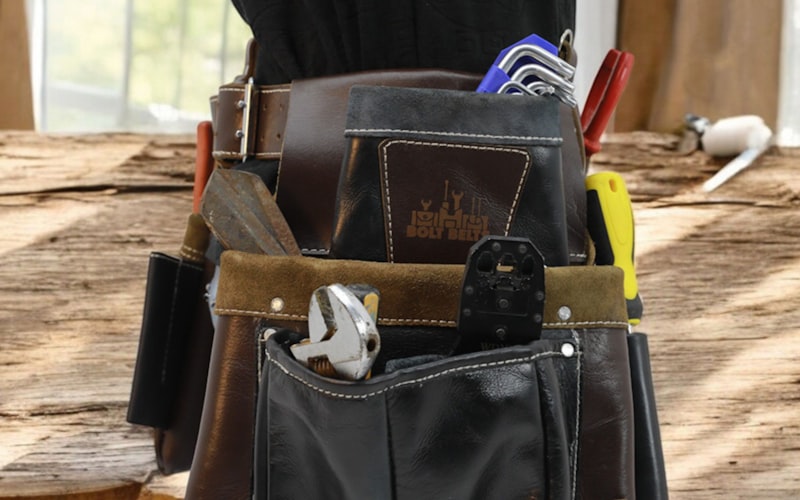 Professional leather tool belt filled with handyman tools
